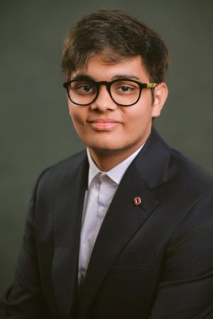 Portrait of Yashwardhan Joshi, an Ohio State student, smiling outdoors.